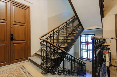 a spiral staircase in a home with a wooden door at DeLux Apartament OldTown Kochanowskiego 30 Kraków in Kraków