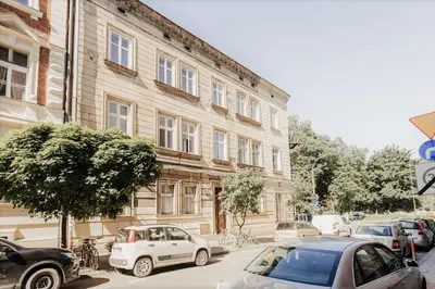 a building with cars parked in front of it at DeLux Apartament OldTown Kochanowskiego 30 Kraków in Kraków