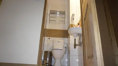 a small bathroom with a toilet and a sink at AMBER APARTAMENt 10 in Kraków
