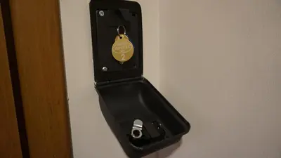 a black object is hanging on a wall at AMBER APARTAMENt 10 in Kraków