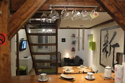 a room with a wooden table and a spiral staircase at Samurai - Old Town, Main Square, Main station in Kraków