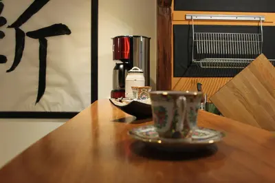 a coffee cup sitting on a wooden table at Samurai - Old Town, Main Square, Main station in Kraków