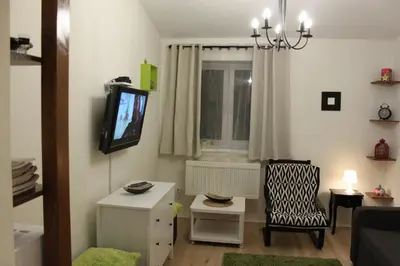 a living room with a tv and a chair at Samurai - Old Town, Main Square, Main station in Kraków