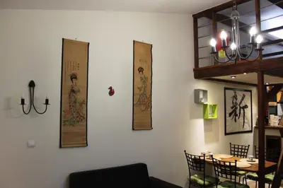 a room with a table with chairs and posters on the wall at Samurai - Old Town, Main Square, Main station in Kraków