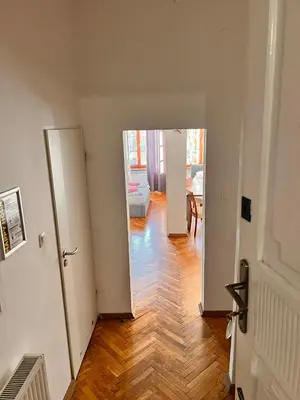a hallway with a door open to a living room at Family Apartament in Kraków