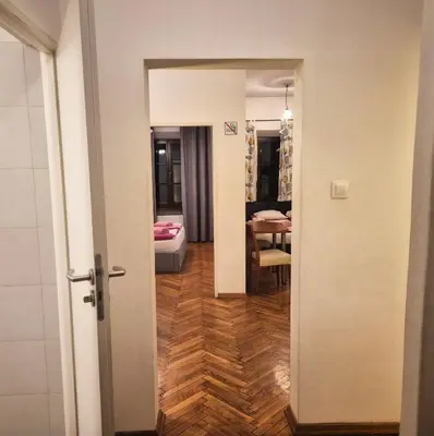 a hallway with a door leading to a room at Family Apartament in Kraków
