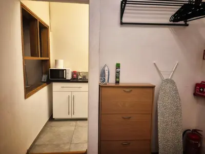 a small kitchen with a cabinet and a microwave at Family Apartament in Kraków
