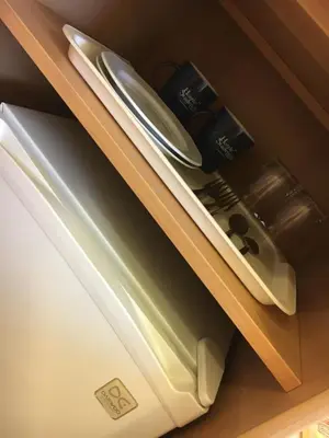 a refrigerator with its door open in a drawer at Piast Hotele Studenckie in Kraków