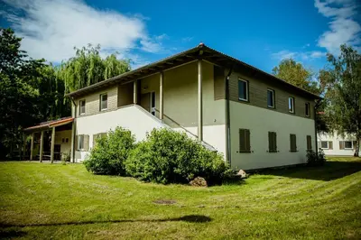 a house with a grass yard in front of it at Międzynarodowy Dom Spotkań Młodzieży w Oświęcimiu in Oświęcim