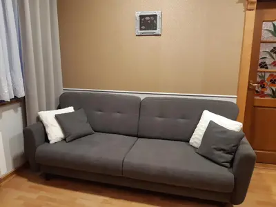 a dining room with a table and chairs and a television at SECESJA HOUSE in Oświęcim