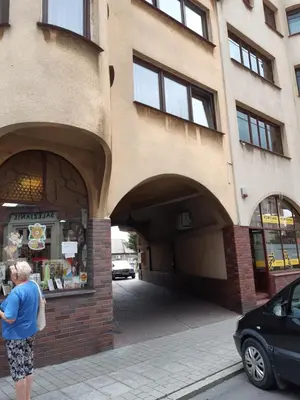 a woman standing in front of a building at SECESJA HOUSE in Oświęcim