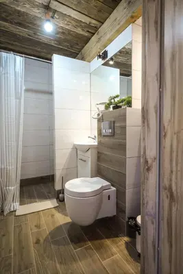 a bathroom with a white toilet and a sink at Willa Zator in Oświęcim