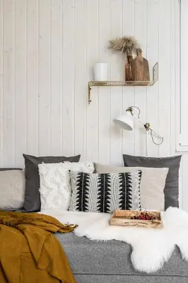 a living room with a couch with pillows and a lamp at ZATORHOUSE in Zator