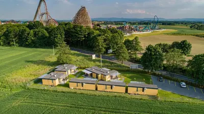 an aerial view of a train yard with a roller coaster at ZATORHOUSE in Zator