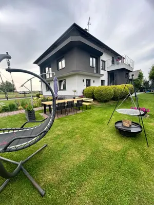 a playground in a yard with a house at Noclegi u Alicji in Wola Kalinowska