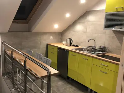 a kitchen with green cabinets and a sink at Noclegi u Alicji in Wola Kalinowska