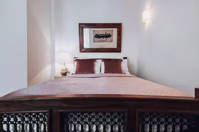a bed in a bedroom with a picture on the wall at Szpitalna 20 Apartment nr 8 in Kraków