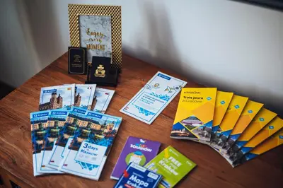 a table with books and pamphlets on top of it at Szpitalna 20 Apartment nr 8 in Kraków
