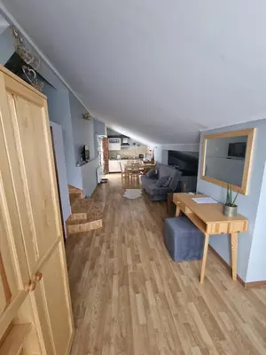 a living room with a couch and a table at Gospodarstwo Agroturystyczne Borówkowy Bukiet Smaków in Iwkowa