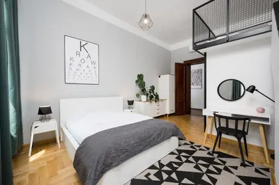 a white bedroom with a bed and a desk at Beautiful apartment, great location, Old Town & Kazimierz in Kraków