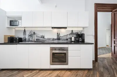 a kitchen with white cabinets and a stove top oven at Beautiful apartment, great location, Old Town & Kazimierz in Kraków