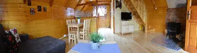 a living room of a log cabin with a stove at Domek drewniany Camila in Ryczów