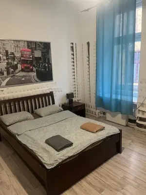 a bedroom with a bed and a red bus at Coco apartment 1 in Kraków