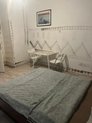 a room with a table and two chairs and a rug at Coco apartment 1 in Kraków