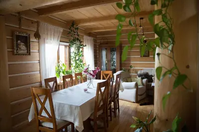 a dining room with a white table and chairs at Śmietanówka Agroturystyka in Krzczonów