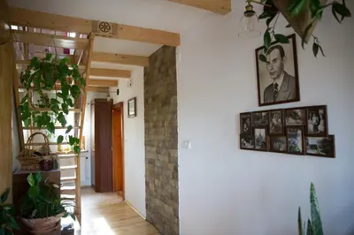 a hallway with plants and pictures on the wall at Śmietanówka Agroturystyka in Krzczonów