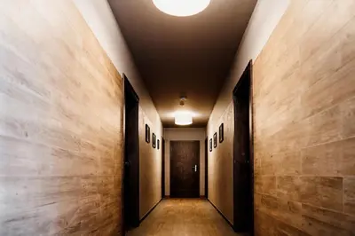a hallway with wooden walls and a ceiling with a door at Róża Rooms in Zator