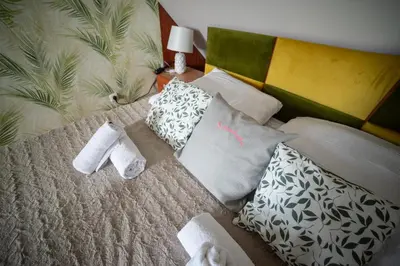 a bed with two towels and pillows on it at Willa Sulimówka - wyjątkowy dom na wyłączność Mini SPA in Zakliczyn