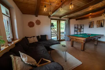 a living room with a couch and a pool table at Willa Sulimówka - wyjątkowy dom na wyłączność Mini SPA in Zakliczyn