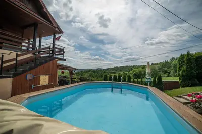 a large blue swimming pool next to a building at Willa Sulimówka - wyjątkowy dom na wyłączność Mini SPA in Zakliczyn