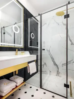 a bathroom with a sink and a shower at Hotel Golden Queen in Kraków