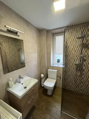 a bathroom with a sink and a toilet and a shower at Apartamenty ZATOR20 2 min od Energylandii in Zator