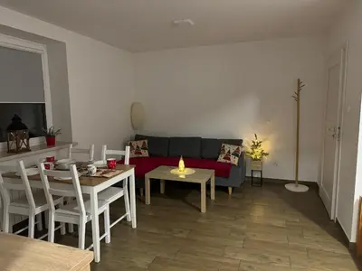 a living room with a couch and a table at Apartamenty ZATOR20 2 min od Energylandii in Zator
