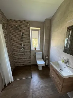 a bathroom with a toilet and a shower and a sink at Apartamenty ZATOR20 2 min od Energylandii in Zator