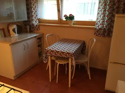 a room with a table and a bed and a table and chairs at MARYSIEŃKA in Zawoja