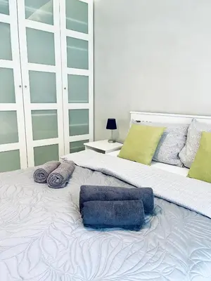 a large bedroom with two beds with towels on them at Modern Silver Apartment in Kraków