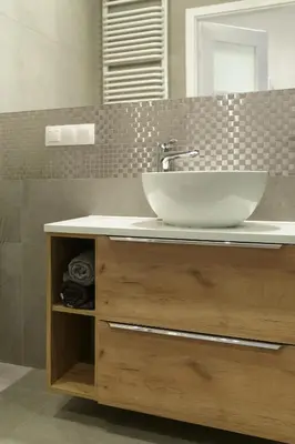 a bathroom with a sink with a large bowl at Modern Silver Apartment in Kraków