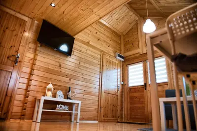 a room with a wooden wall with a table in it at Nocleg Zator Domki Paradise Pod Palmami in Zator