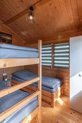 a cabin with two bunk beds in it at Nocleg Zator Domki Paradise Pod Palmami in Zator