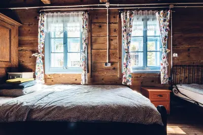 a bedroom with two windows and a bed in it at Kogutowo Agroturystyka MPR in Wietrzychowice