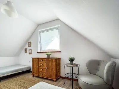 a bedroom with a bed and a wooden door at Domek pod Mogielicą in Chyszówki
