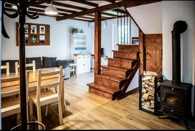 a kitchen with a wood stove in a kitchen at Domek pod Mogielicą in Chyszówki