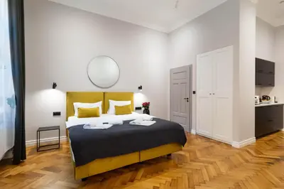 a table with two glasses of wine and a candle at Nola Apartments in Kraków