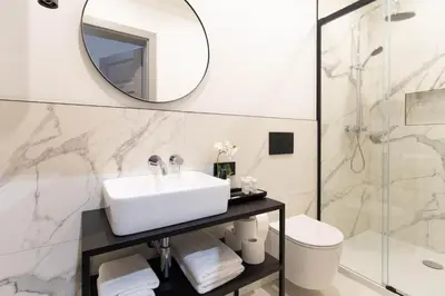 a bedroom with a large bed with a mirror on the wall at Nola Apartments in Kraków