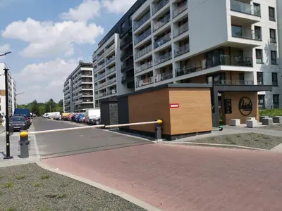 a parking lot in front of a large building at Apartament Kraków Arena No. 100 in Kraków