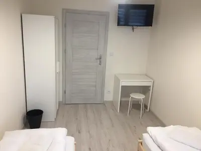 a white room with a desk and a table and a chair at Apartament Kraków Arena No. 100 in Kraków